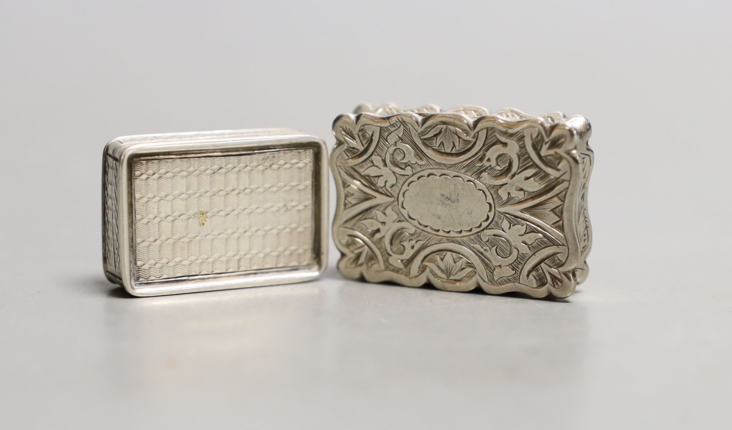 A Victorian engraved silver vinaigrette, D & M, Birmingham, 1876, 35mm and a smaller earlier vinaigrette by Francis Clark.